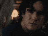 a close up of a man 's face with a dark background