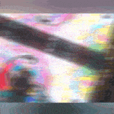 a blurred image of a person 's face with a rainbow of colors