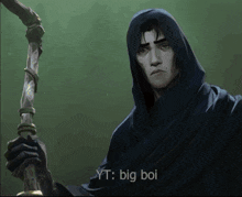 a man in a hooded cloak is holding a cane and says " big boi "