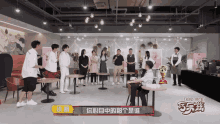 a group of people standing around a table with a sign that says ' 小明 ' on it