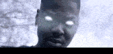 a close up of a person 's face with glowing eyes looking at the camera .