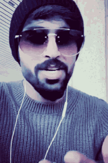 a man with a beard wearing sunglasses and a hat