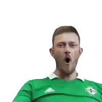 a man in a green adidas shirt is making a fist