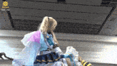 a woman in a costume with the hashtag #pw_mg on the bottom