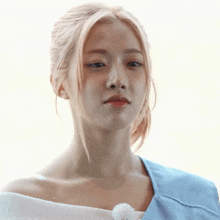 a woman with blonde hair is wearing a blue top