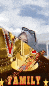 a woman wearing a hijab and sunglasses is standing in front of a trophy that says family