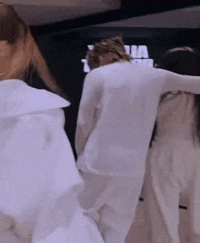 a group of people are standing next to each other in a room .