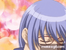 a close up of a person 's face wearing glasses and purple hair .