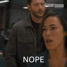a woman says nope while standing in front of a man