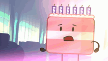 a pink cake with candles on top of it