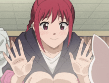 a girl with red hair is waving her hands in front of her face