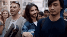a group of men are standing next to each other in a crowd with the words made with reface app on the bottom
