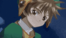 a close up of a boy wearing a green jacket and hat