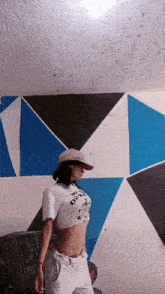 a woman wearing a hat and a crop top that says " i love you " on it