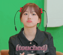 a girl wearing a black jacket that says touched