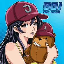 a girl wearing a baseball cap with the letter j on it holding a teddy bear
