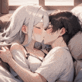 a man and a woman kissing in bed with their eyes closed