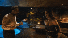 a man and woman are having a conversation in a dark room