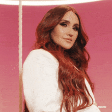 a woman with long red hair is wearing a white jacket with rbd3d on the bottom right