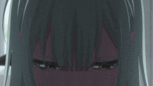 a close up of a girl 's face with a very serious look on her face