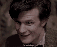 a close up of a man 's face with the words " you are beautiful " next to him