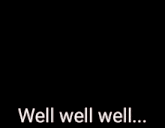 a black and white photo of a person standing in front of a wall with the words `` well well well '' written on the ground .