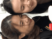 a woman 's head is resting on another woman 's shoulder while they smile for the camera