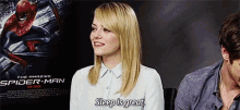 a woman is sitting in front of a spider-man poster and says sleep is great .