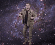 a man is standing in the middle of a galaxy .