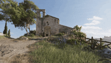 a church with a bell tower is surrounded by tall grass