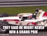a race car is driving down a race track and they said he might never win a grand prix .