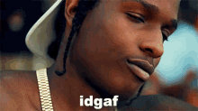 a close up of a man 's face with the word idgaf written above him