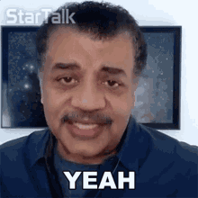 a man with a mustache is saying yeah