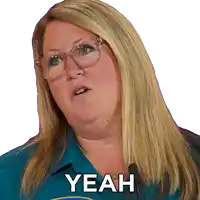 a woman wearing glasses and a blue shirt says " yeah "