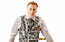 a man in a striped shirt and vest says " i don t want to fight what "