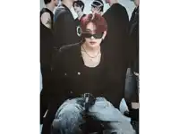 a young man with red hair wearing sunglasses and a necklace