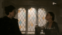 two women talking in front of a stained glass window with the words still your leading lady on the bottom