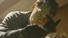 a close up of a man wearing gloves looking at something