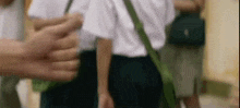 a blurry picture of a person holding another person 's hand while walking .