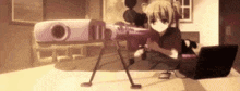 a girl is holding a sniper rifle in front of a laptop .