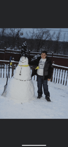 a boy standing next to a snowman wearing a t-shirt that says ' ucsd ' on it