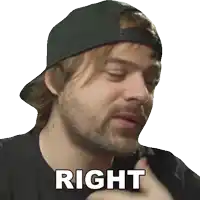 a man with a beard wearing a black hat and a black shirt says right
