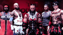 a group of wrestlers are standing in front of a sign that says the bloodhounds