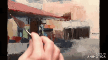 a person is painting a picture with the words made in animotica below