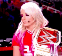 a woman is wearing a pink shirt with the number 3 on it