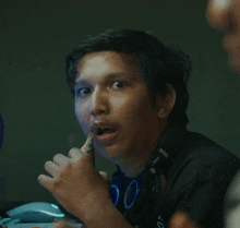 a man wearing headphones and a shirt that says 00 on it