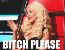 a blonde woman is sitting in a red chair with the words bitch please written on it