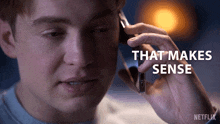 a man talking on a cell phone with the words that makes sense