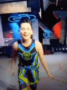 a man in a blue and yellow outfit is smiling and holding a rope