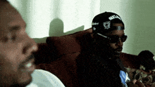 a man wearing a hat that says oakland raiders